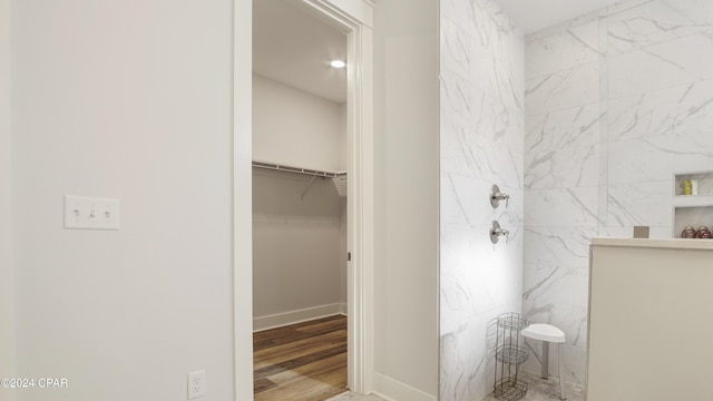 bathroom featuring wood-type flooring and walk in shower