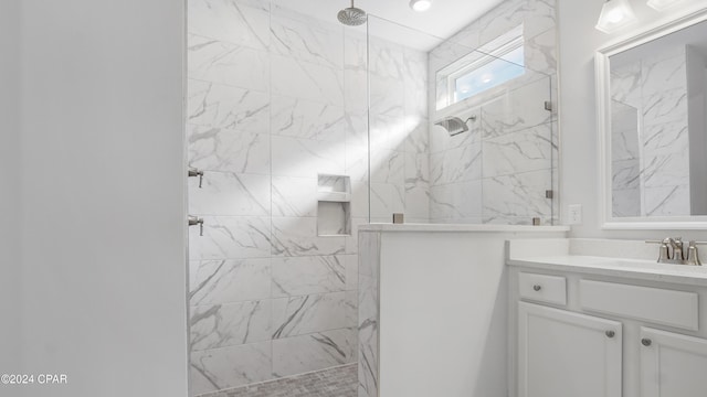 bathroom featuring vanity and tiled shower