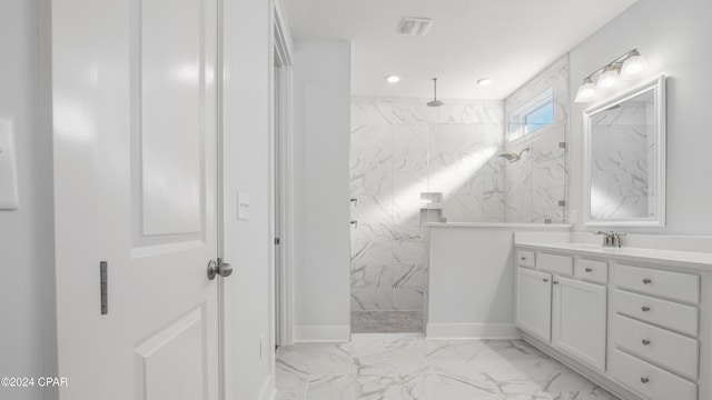 bathroom featuring vanity and tiled shower