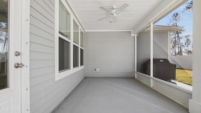 unfurnished sunroom with a wealth of natural light and ceiling fan