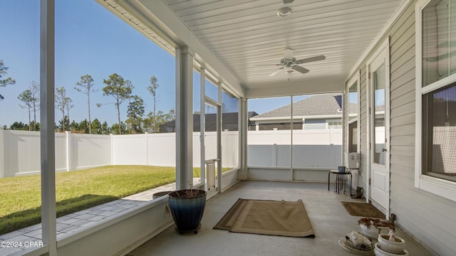 unfurnished sunroom with ceiling fan