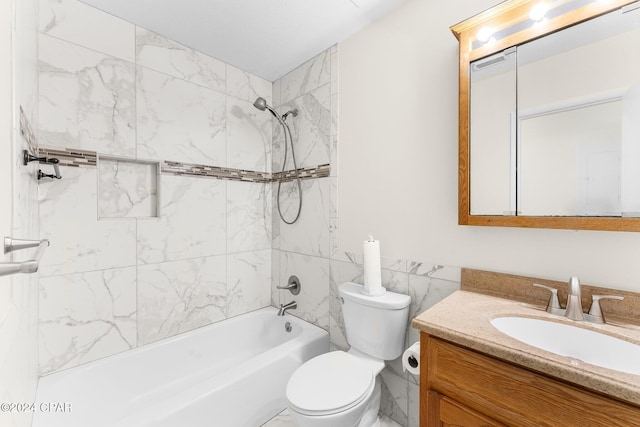 full bathroom featuring tiled shower / bath combo, vanity, and toilet