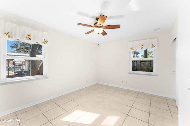 spare room featuring ceiling fan and light tile patterned floors