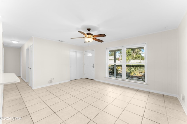 empty room featuring light tile patterned flooring and ceiling fan