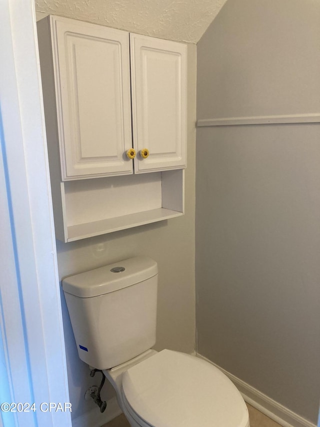 bathroom featuring a textured ceiling and toilet