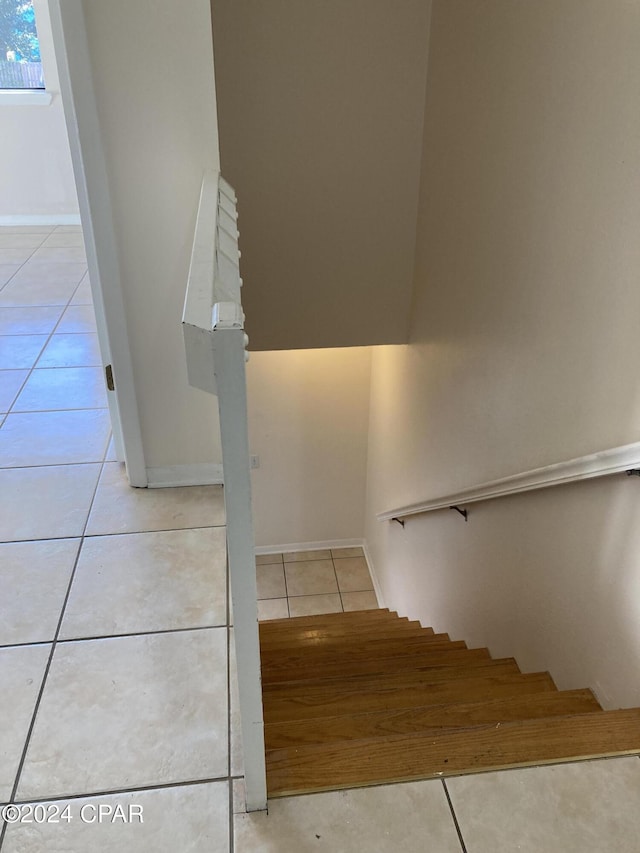 staircase featuring tile patterned floors