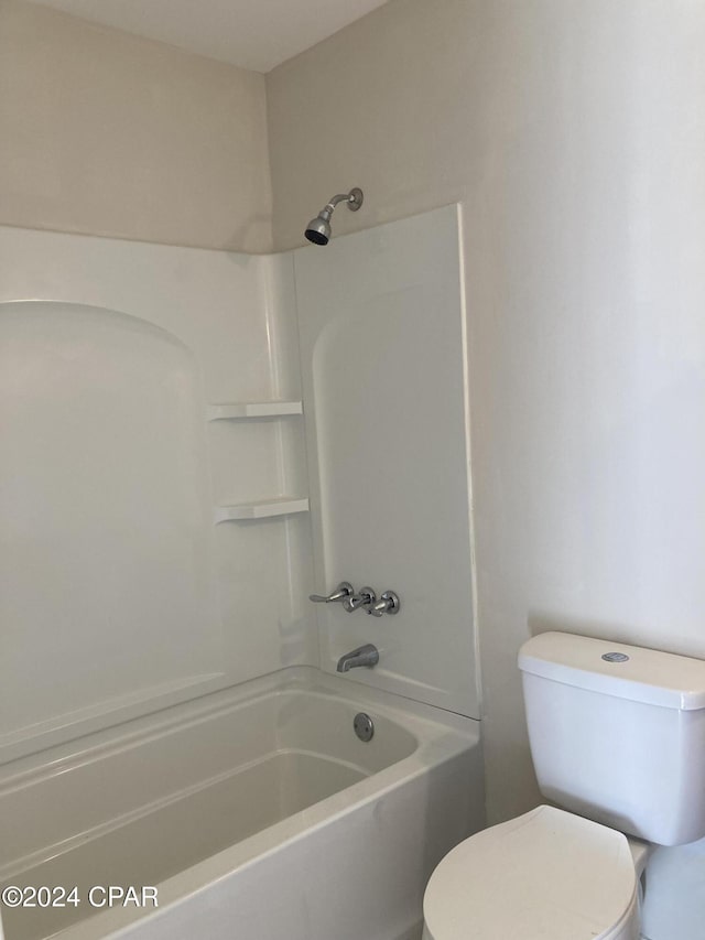 bathroom featuring shower / bathtub combination and toilet