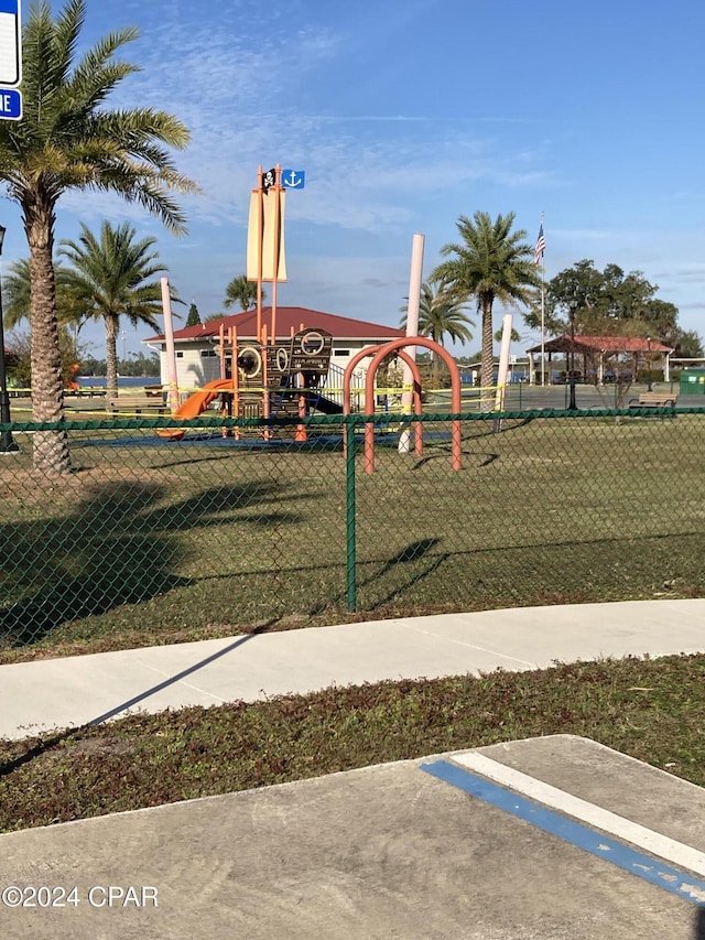 view of playground with a lawn