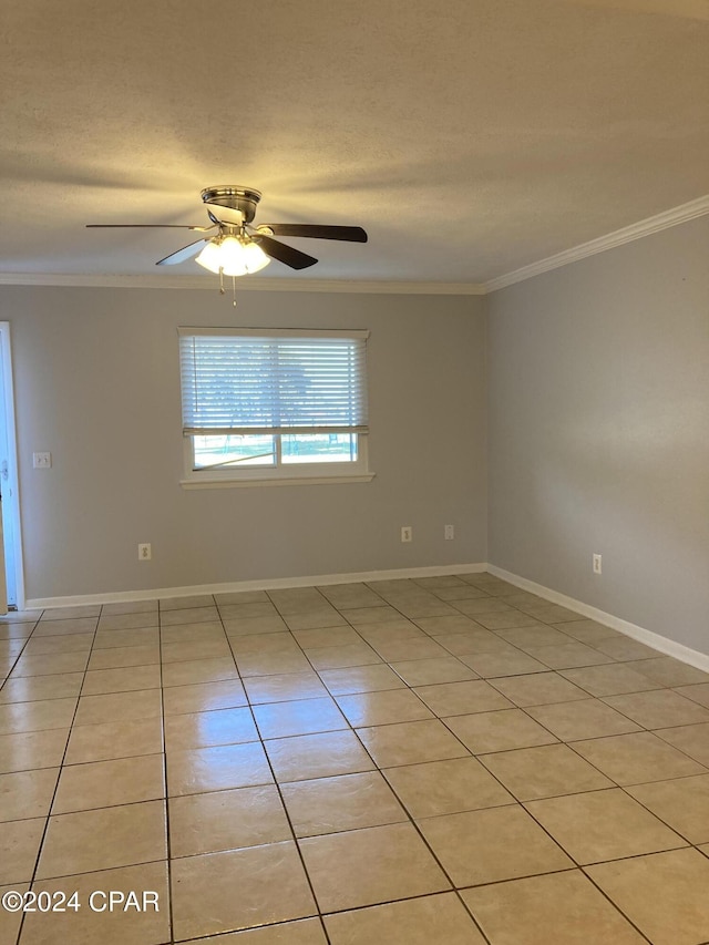 empty room featuring light tile patterned floors, a textured ceiling, ceiling fan, and ornamental molding