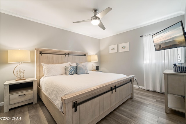 bedroom featuring ceiling fan, hardwood / wood-style floors, and ornamental molding