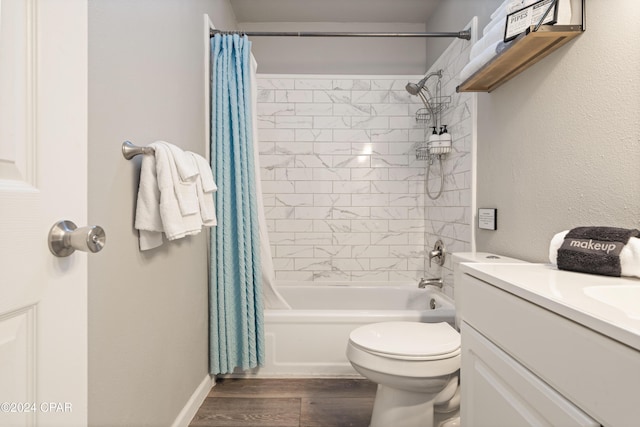 full bathroom with vanity, toilet, wood-type flooring, and shower / tub combo