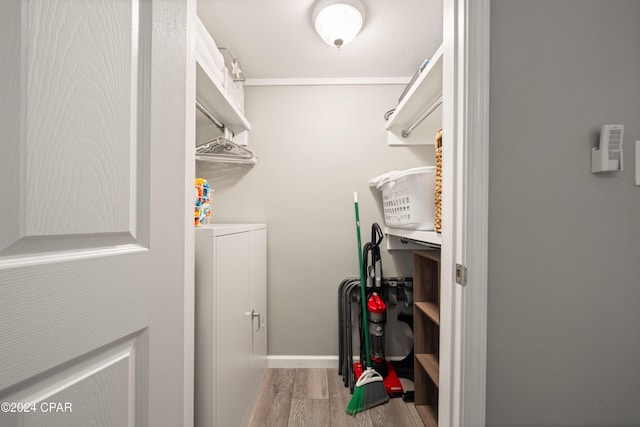 laundry room featuring light wood-type flooring