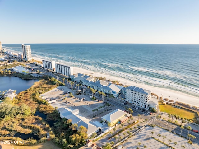 aerial view with a water view and a beach view