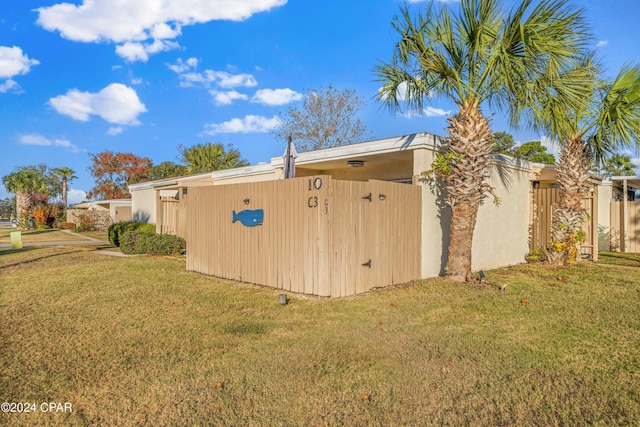 view of side of home with a yard