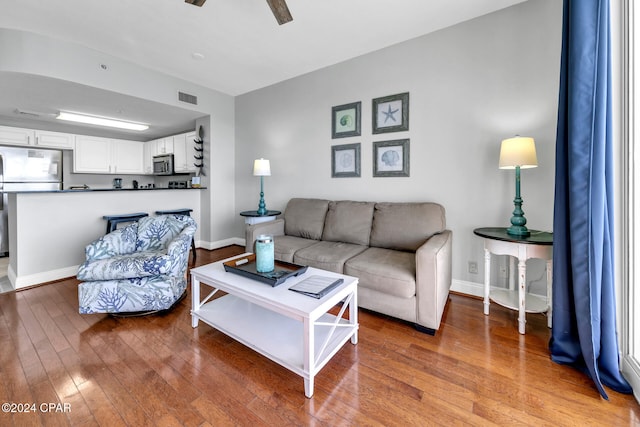 living room with ceiling fan and wood-type flooring