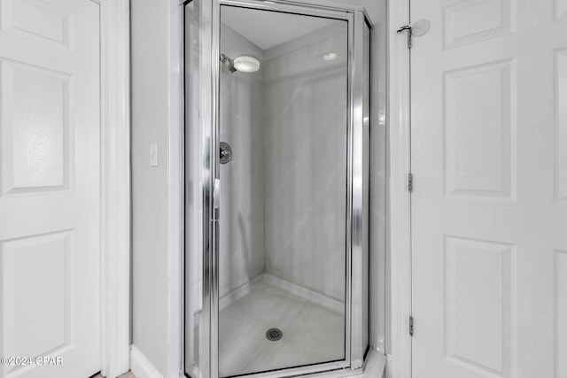 bathroom with a shower with door