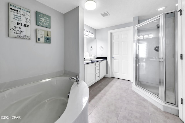 bathroom with tile patterned flooring, vanity, and independent shower and bath