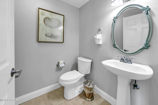 bathroom featuring tile patterned floors, sink, and toilet