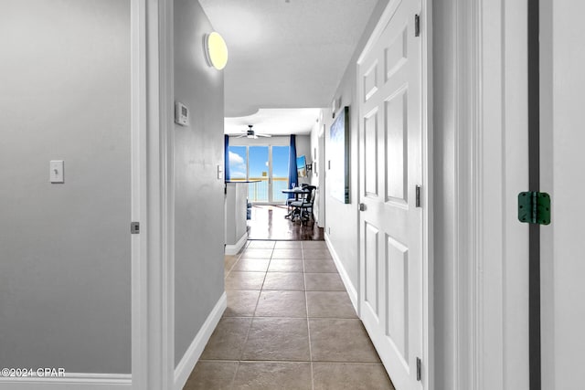 hallway featuring light tile patterned floors