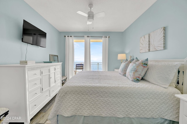 bedroom with a ceiling fan, access to outside, and dark wood finished floors