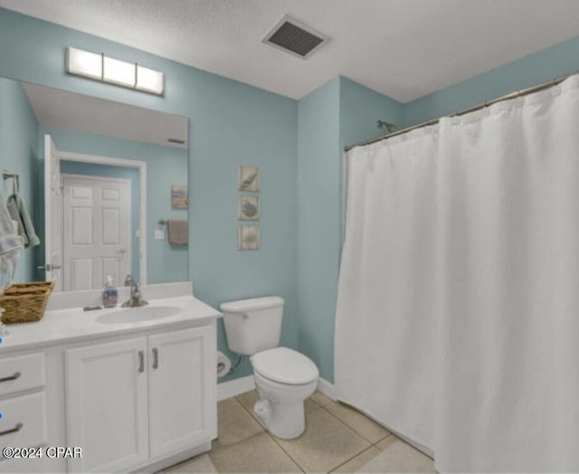 bathroom featuring visible vents, toilet, vanity, baseboards, and tile patterned floors