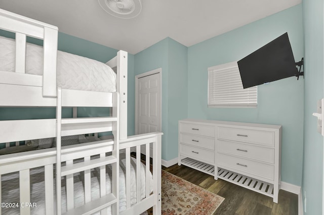 bedroom with baseboards and wood finished floors