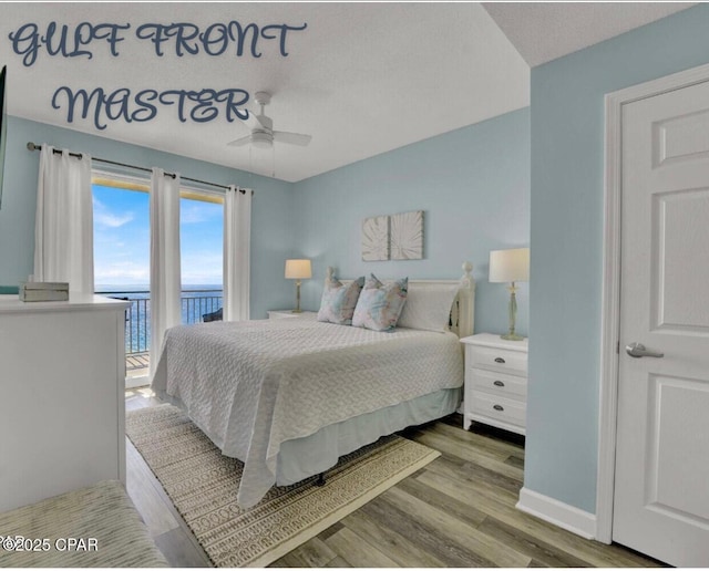 bedroom with ceiling fan, access to outside, wood finished floors, and baseboards