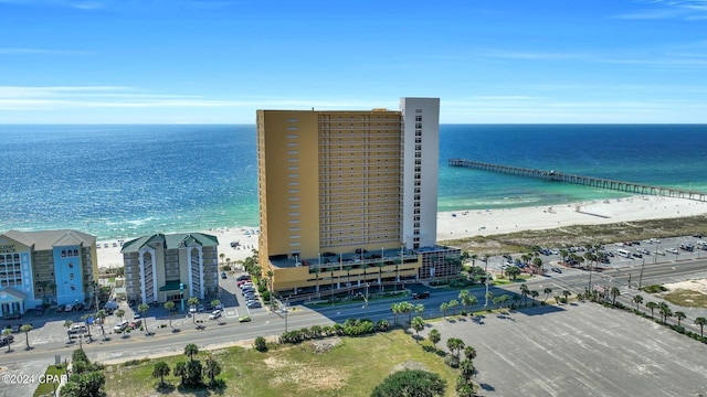 drone / aerial view featuring a beach view and a water view