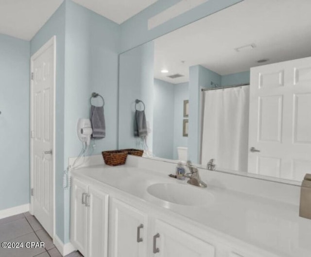 full bath with a shower with shower curtain, vanity, baseboards, and tile patterned floors