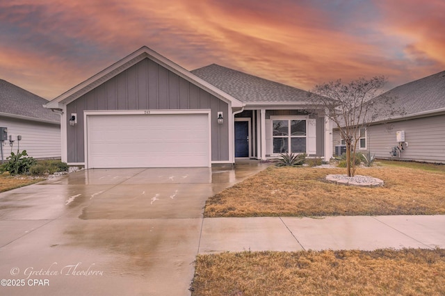 ranch-style home featuring a yard and a garage