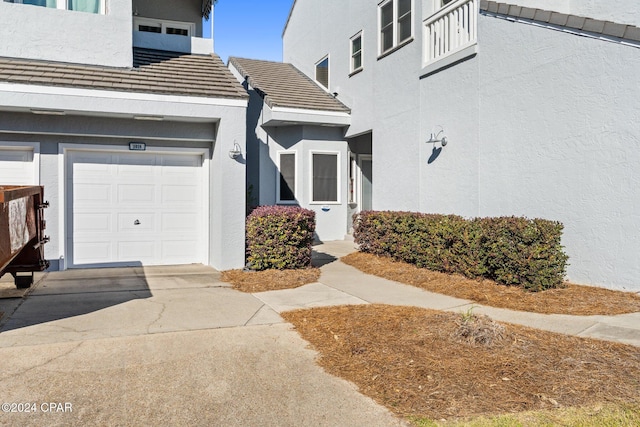 doorway to property with a garage