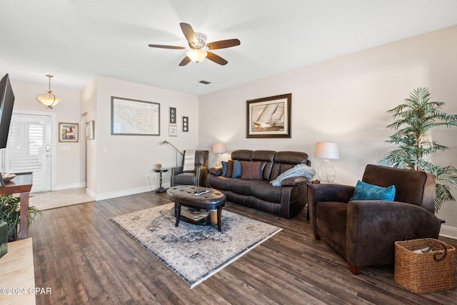 living room with dark wood-type flooring and ceiling fan