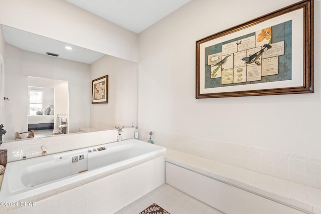 bathroom featuring tiled tub and tile patterned floors