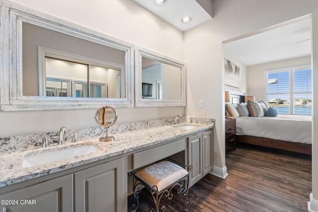 bathroom with hardwood / wood-style flooring, vanity, and a water view