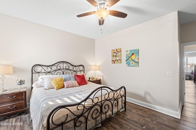 bedroom with ceiling fan and dark hardwood / wood-style flooring