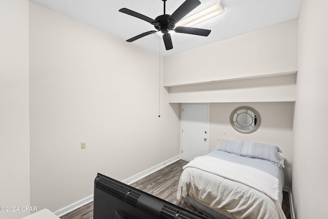 bedroom with ceiling fan and dark hardwood / wood-style flooring