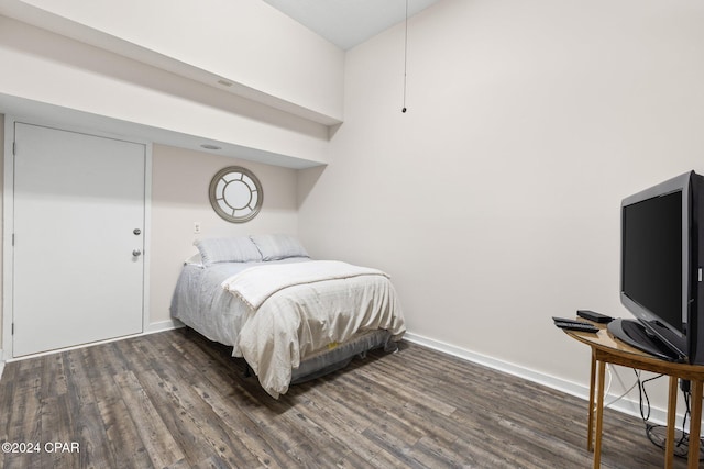 bedroom with dark hardwood / wood-style floors