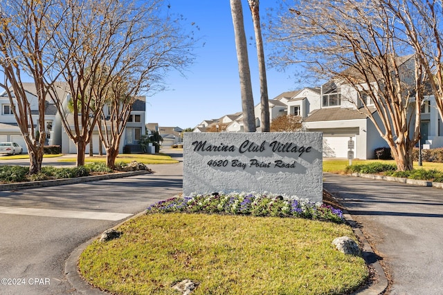 community sign featuring a lawn