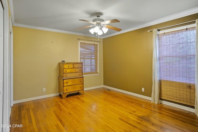 unfurnished bedroom featuring crown molding, light wood-type flooring, and ceiling fan