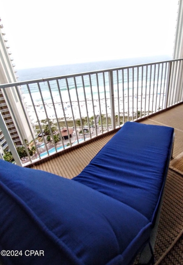 balcony featuring a water view and a view of the beach