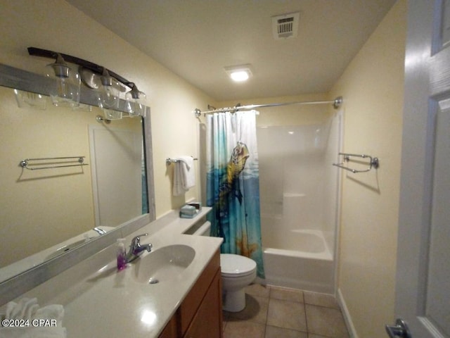 full bathroom with tile patterned floors, vanity, shower / tub combo, and toilet