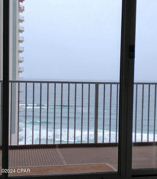 balcony with a beach view and a water view