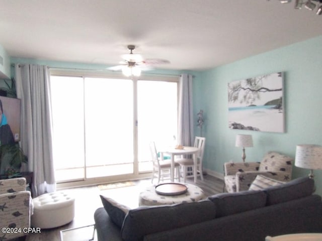 living room featuring hardwood / wood-style flooring, plenty of natural light, and ceiling fan