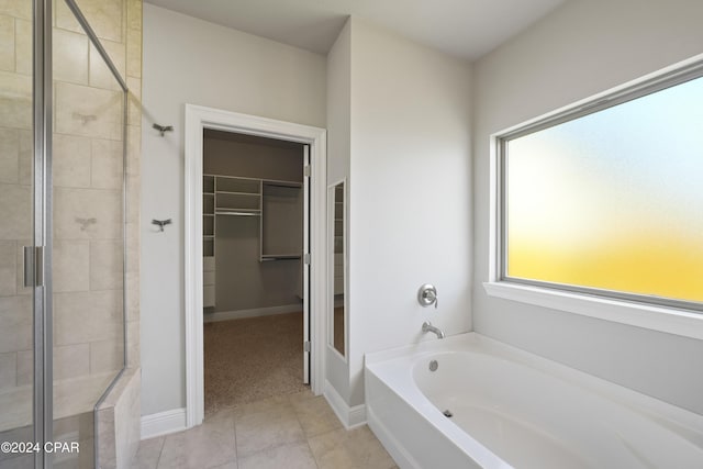 bathroom with tile patterned floors and shower with separate bathtub