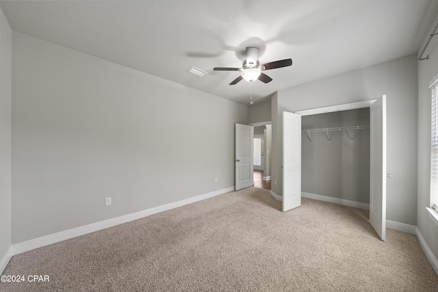 unfurnished bedroom with carpet, ceiling fan, and a closet