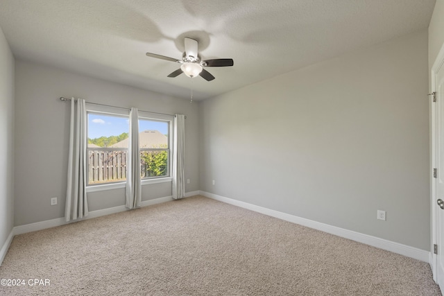 empty room with light carpet and ceiling fan