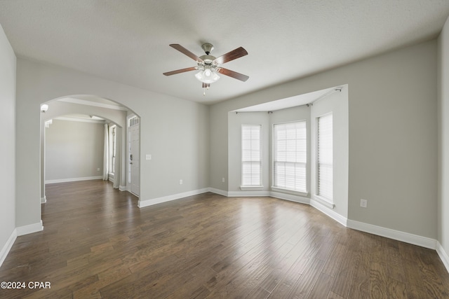 empty room featuring ceiling fan and dark hardwood / wood-style floors