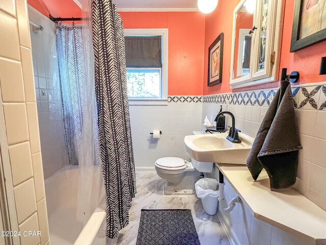 full bathroom with sink, shower / tub combo, tile walls, ornamental molding, and toilet