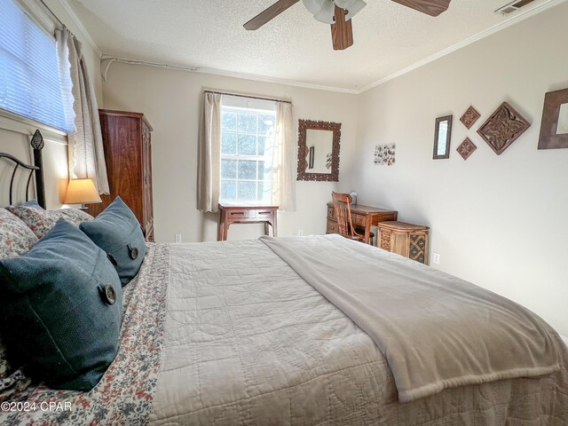 bedroom with crown molding, ceiling fan, and a textured ceiling