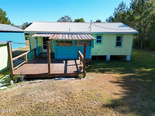 view of dock featuring a wooden deck and a yard